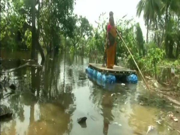 Villagers use handmade rafts for commute in submerged villages in WB's East Midnapore (photo/ANI) 