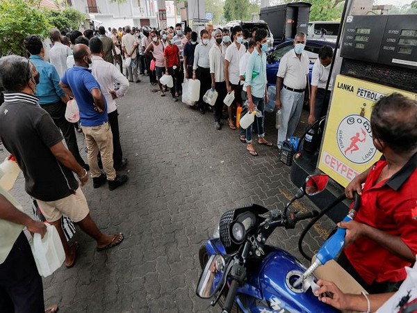 People wait in a line to buy petrol at a Ceylon Ceypetco fuel station on a main road, amid the country's economic crisis in Colombo, Sri Lanka (Photo Credit: Reuters)
