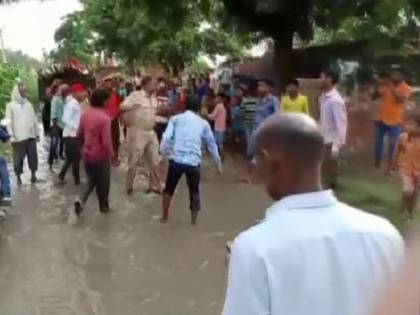 The head constable being thrashed by a group of youngsters in the video. Photo/ANI