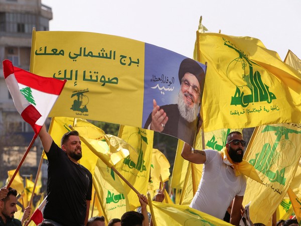 Supporters of Lebanon's Hezbollah leader Sayyed Hassan Nasrallah and Amal Movement carry flags while riding in a convoy as votes are being counted (Photo Credit: Reuters)