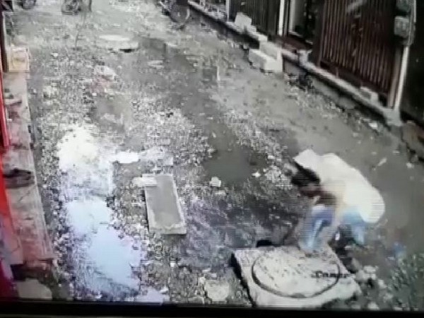 Visuals of a man rescuing a child from a gutter n Jodhpur. (Photo/ANI)