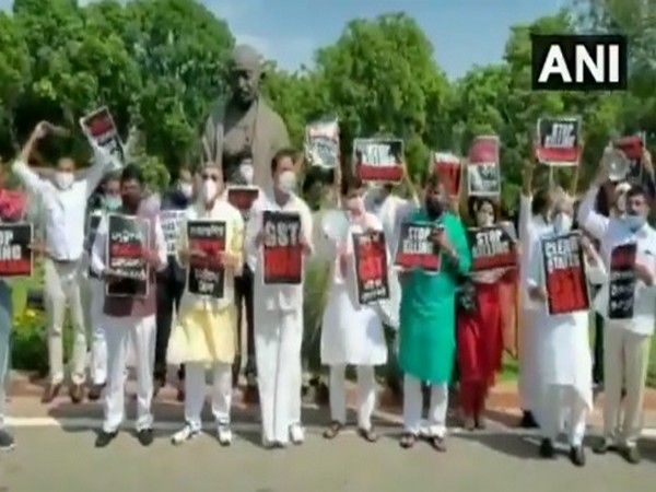 MPs protest at Parliament premises demanding GST payments to states. Photo/ANI