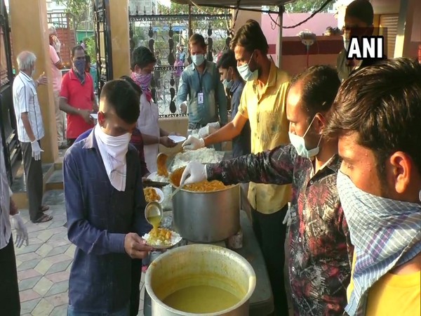 Jalaram Seva Samaj Trust volunteers providing food to the needy on Saturday. 