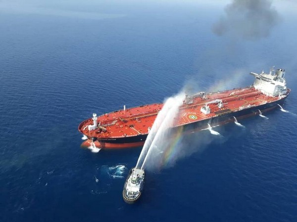 An Iranian navy boat tries to stop the fire of an oil tanker after it was attacked in the Gulf of Oman on June 13