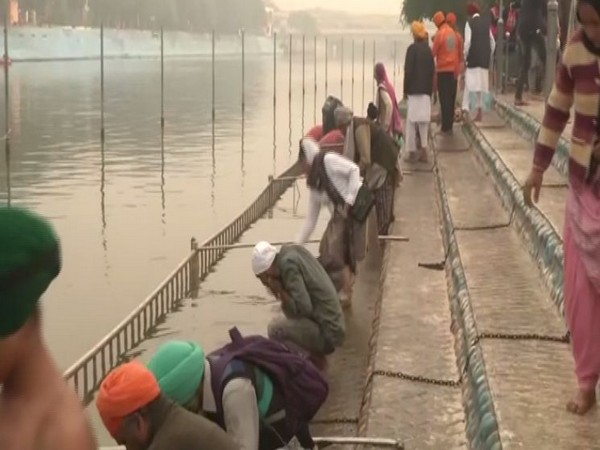 Devotees takes holy dip at the river near Ber Sahib Gurudwara on Guru Nanak Jayanti. Photo/ANI