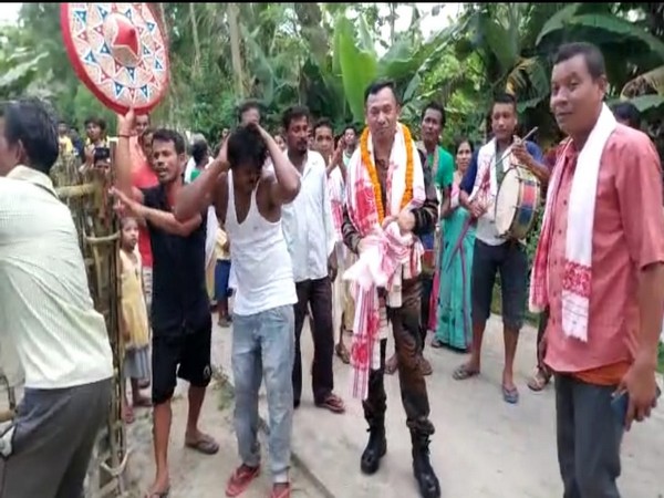 Villagers in Assam's Bualguri village accord grand welcome to Dharani Bora. (ANI/photo)