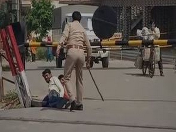 Police make labourers roll on road in Hapur on Tuesday. Photo/ANI