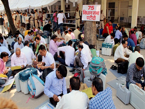 Polling officials checking EVMs and other polling materials before taking them to polling booths on the eve of assembly elections in Pataudi on Sunday. (ANI Photo)