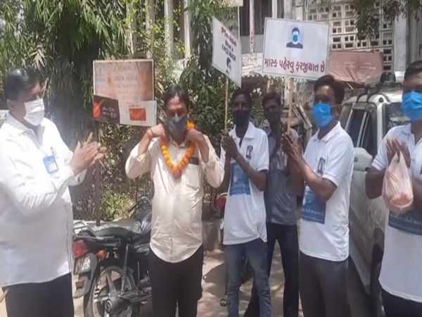 A COVID-19 rule offender being garlanded in Vadodra. (ANI)
