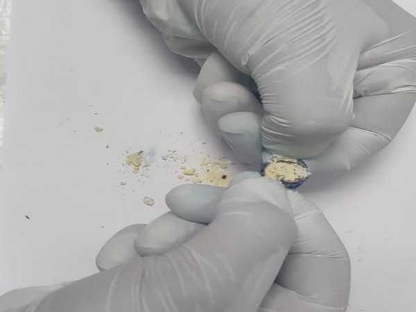 A visual of heroin concealed inside the button of women's gown. Photo/ANI