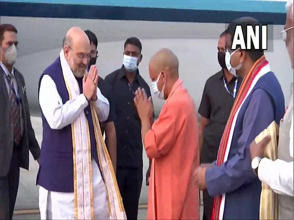 UP CM welcomes Amit Shah as he reaches Varanasi (Photo/ANI)