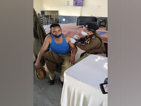 A BSF jawan taking vaccine jab at BSF campus in Bhondsi