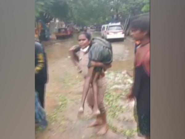 Police inspector carrying the unconscious man on her shoulders to provide him quick medical care. (Photo/ANI)