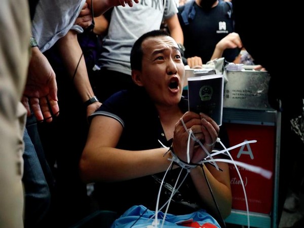Fu Guohao, a reporter with Chinese newspaper Global Times, tied by protesters during demonstrations at Hong Kong airport on Aug 13 (Photo/Reuters)