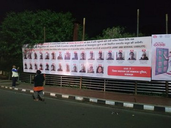 Visual of a hoarding with names and photos of riot-accused people in Lucknow.