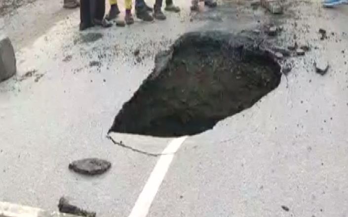 A portion of Basai road caved in, following heavy rainfall on Saturday in Gurugram in Haryana. Photo/ANI