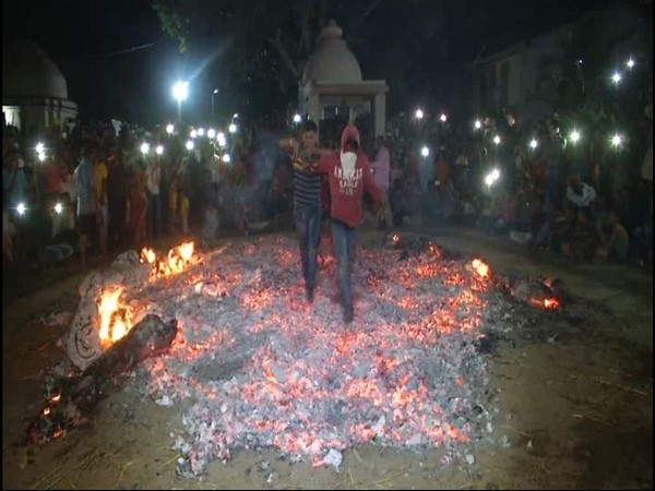 People of Olpad, Surat (Gujarat) walking ember to mark Holi festival on Wednesday.