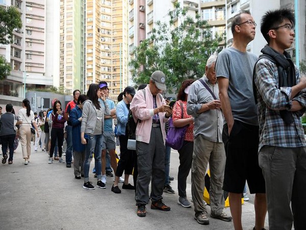 People line up to vote in district council elections in South Horizons in Hong Kong on Sunday.