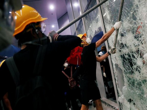 Hong Kong Protesters removed metal fencing and smashed glass doors at the Legislative Council building on Monday evening. 