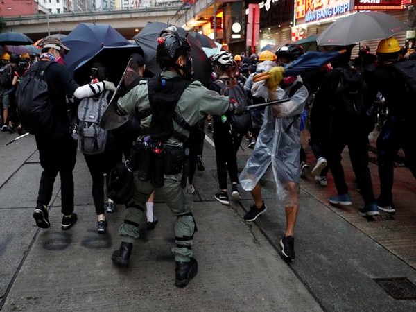 A riot police officer clashes with a protester during an anti-government rally in central Hong Kong on Sunday
