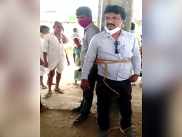 Two electricity department officials tied with a rope in Medak