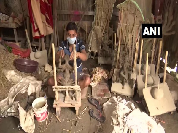 An idol maker making idols in Assam's Guwahati (Photo/ANI)