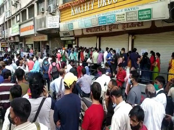 A visual of the people outside the medical store in Indore. Photo/ANI