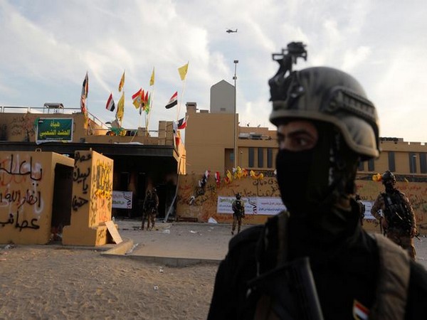 Members of Iraqi security forces in front of US Embassy during a protest to condemn airstrikes on facilities linked to Iranian-backed Kataib Hezbollah militia in Iraq and Syria.