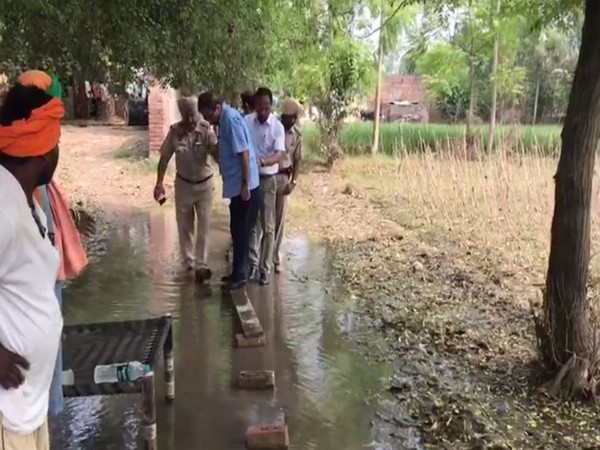 Central team officials make way through a flood affected village in Jalandhar on Friday. Photo/ANI