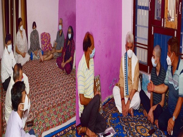 Lt Governor Manoj Sinha visits Municipal Councillor Rakesh Pandita family. (Photo/ ANI)