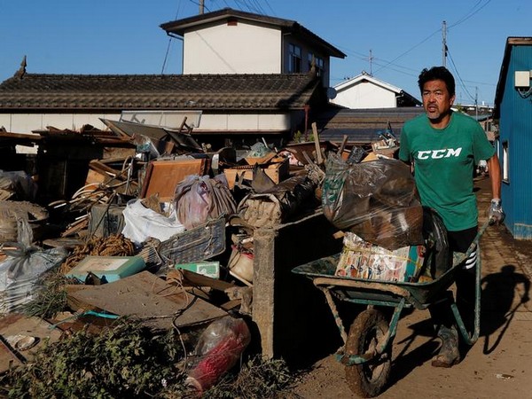 A man cleans debris in the aftermath of Typhoon Hagibis in Yanagawamachi district on Wednesday (Photo/Reuters)