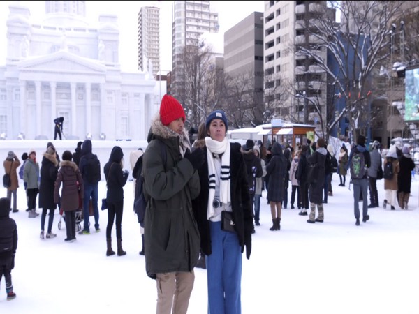Tourists enjoying snow during Sapporo Snow Festival in Japan