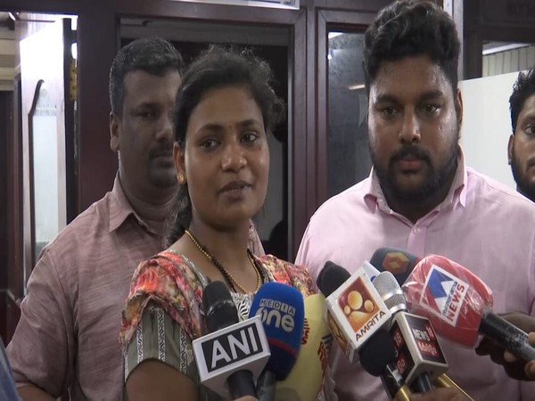 Joisna Mary Joseph (left) with her husband Shejin (on right in pink shirt)