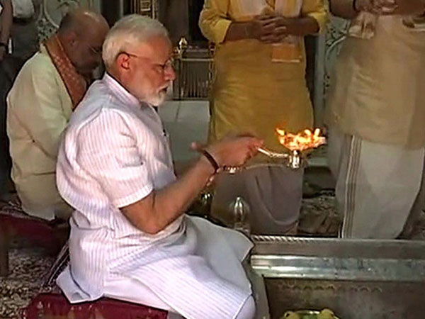 Prime Minister Narendra Modi offers prayers at the Kashi Vishvanath temple along with BJP president Amit Shah in Varanasi on Monday. (ANI Photo)