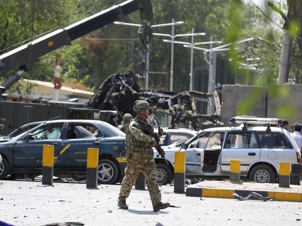 A soldier inspects the site where the car bombing occurred in Kabul on Thursday