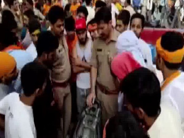 Uttar Pradesh Police personnel with the complainants on Monday in Gajraula. Photo/ANI