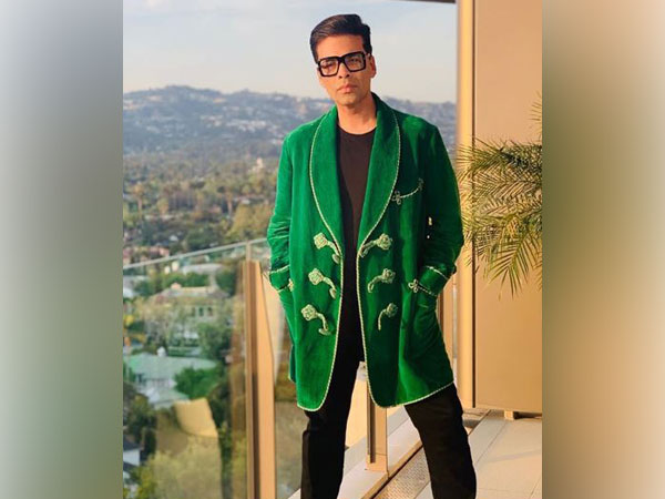 KJo walks IIFA ROCKS green carpet in red