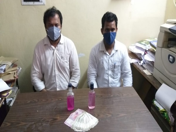 A photo of the two arrested officials in Karimnagar, Telangana.  