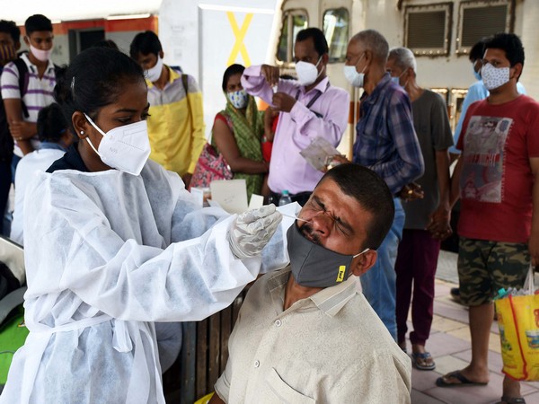 A healthcare worker collecting the swab sample of a man for COVID-19 testing. (Photo/ANI)
