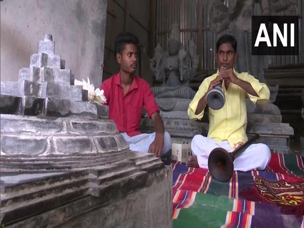 A musician playing 'Nadaswaram' made by Karthik (Photo/ANI)