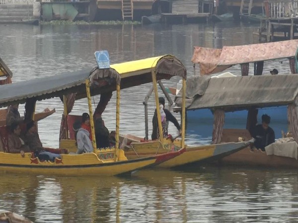 The tourists were seen enjoying a traditional shikara ride in the Dal Lake, Srinagar. (Photo/ANI)