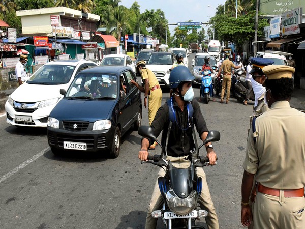 Police personnel stop commuters during lockdown in Kochi on Tuesday. (ANI Photo)