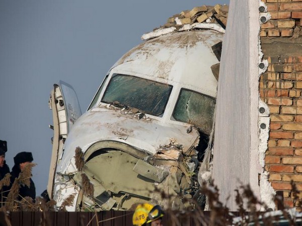 Emergency and security personnel are seen at the site of a plane crash near Almaty, Kazakhstan