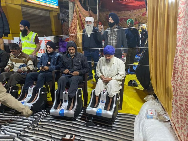 Farmers at Singh border receiving foot massage service provided by Khala Aid on Friday. (Photo/ANI)