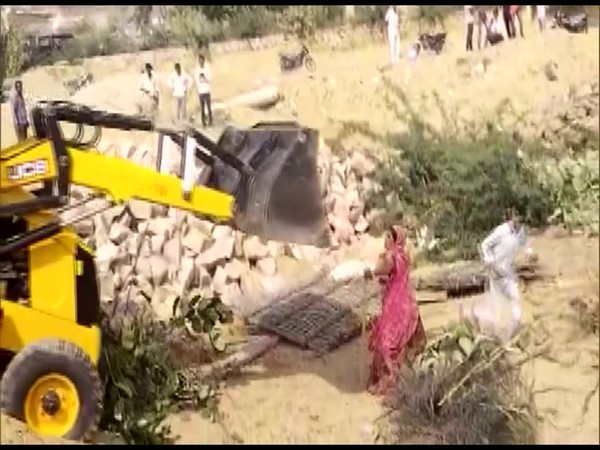 Viral video shows JCB machine trying to mow down a woman in Barmer. (Photo/ANI)