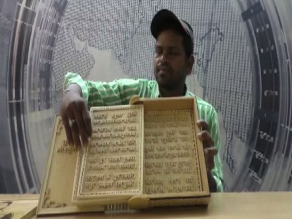 Arun Sahu with the wooden Hanuman Chalisa. 