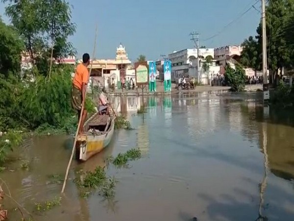 Villagers of Gani Atkuru using boats to travel across the village after the region was hit with heavy rainfall. Photo/ANI