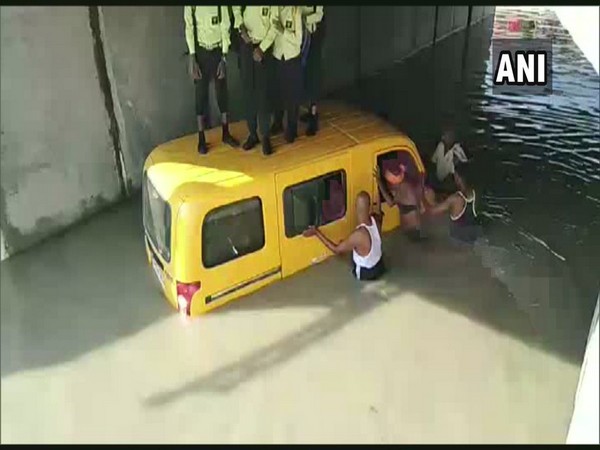 School van stuck in water logged area in Kushinagar on Monday (Photo/ANI)