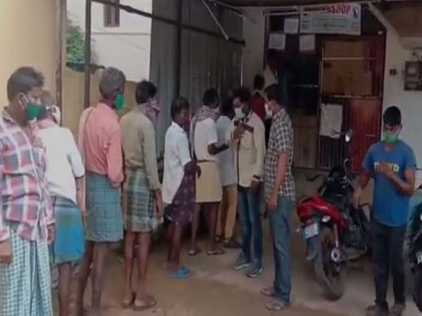 People were seen in large ques in front of liquor shops in Chittoor district on Sunday. (Photo/ANI)