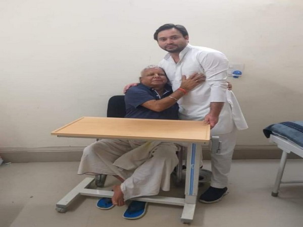 RJD leader Tejashwi Yadav meets his father and party chief Lalu Prasad Yadav in Ranchi on Thursday. (Photo credit: Tejashwi FB)